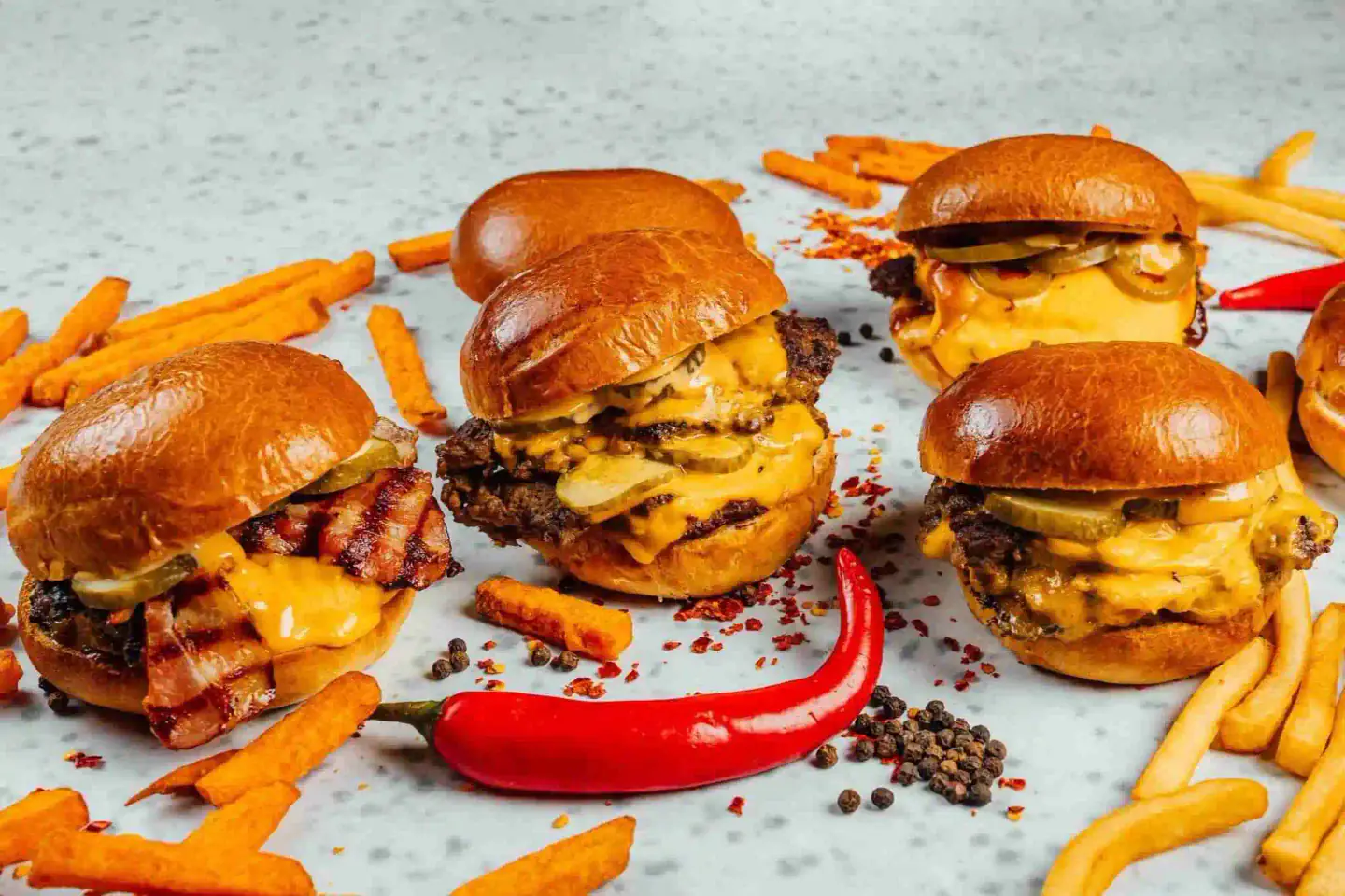 Black Burger-style smash sliders with melted cheese and fries