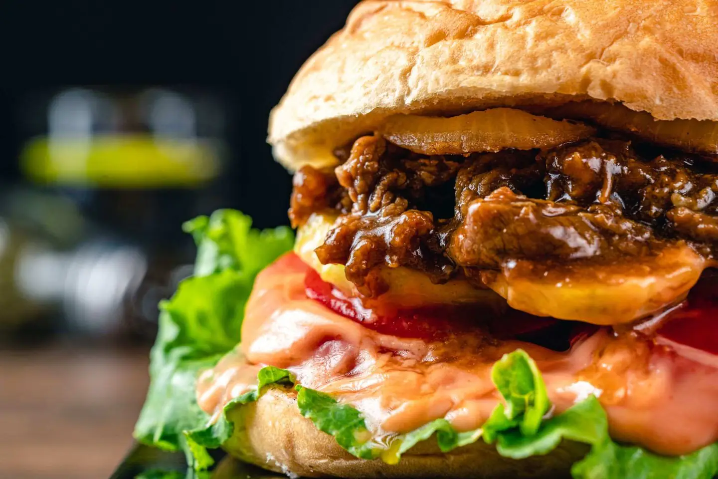 Black Burger with creamy sauce, caramelized onions, lettuce and tomato