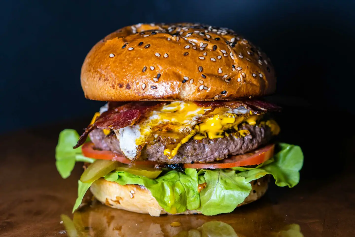 Angus beef burger with melted cheese, bacon, lettuce, tomato
